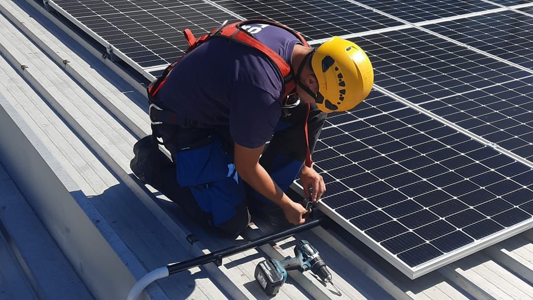 Man installs PV system on a roof